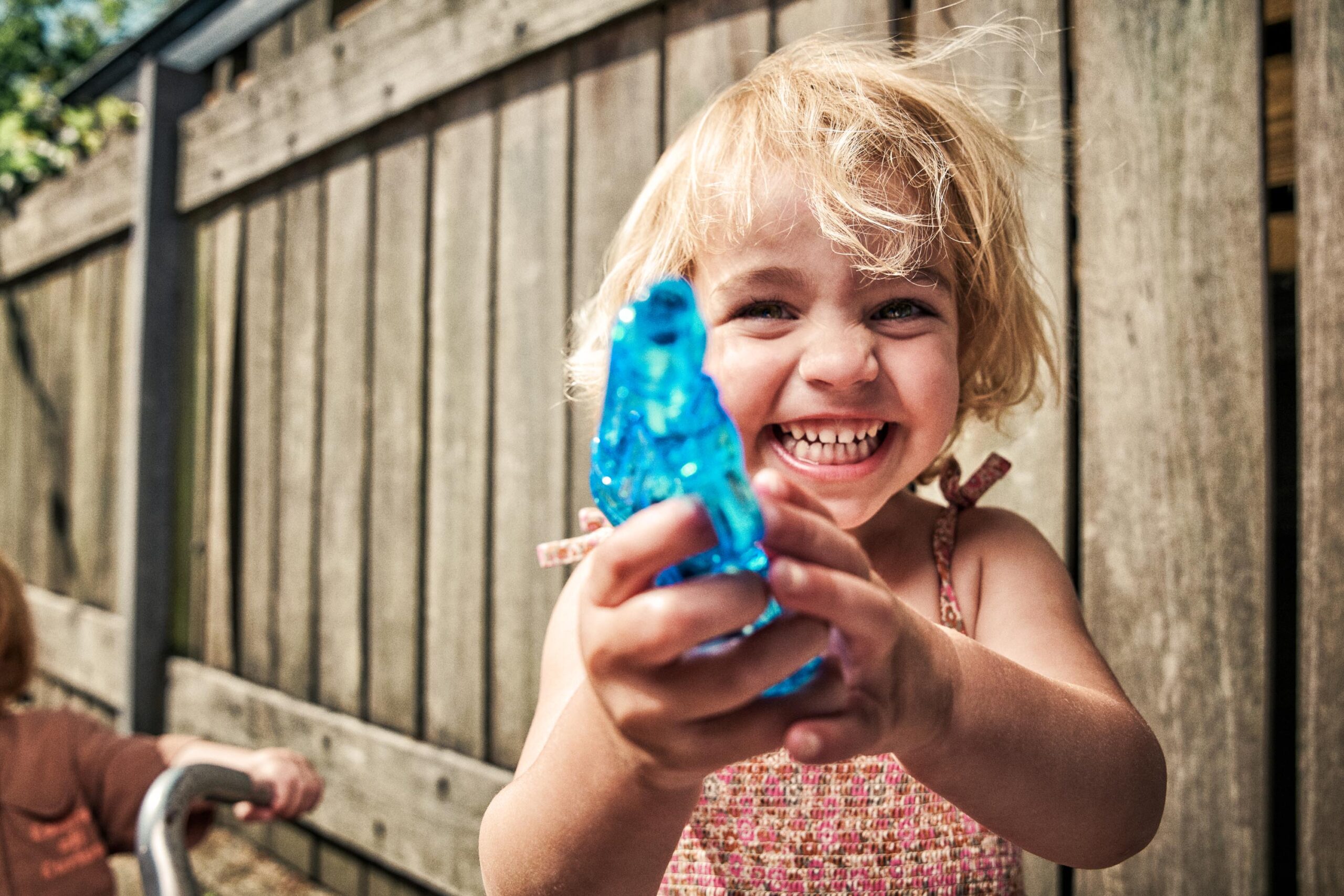 Young girl with a water pistol on a hot summer day