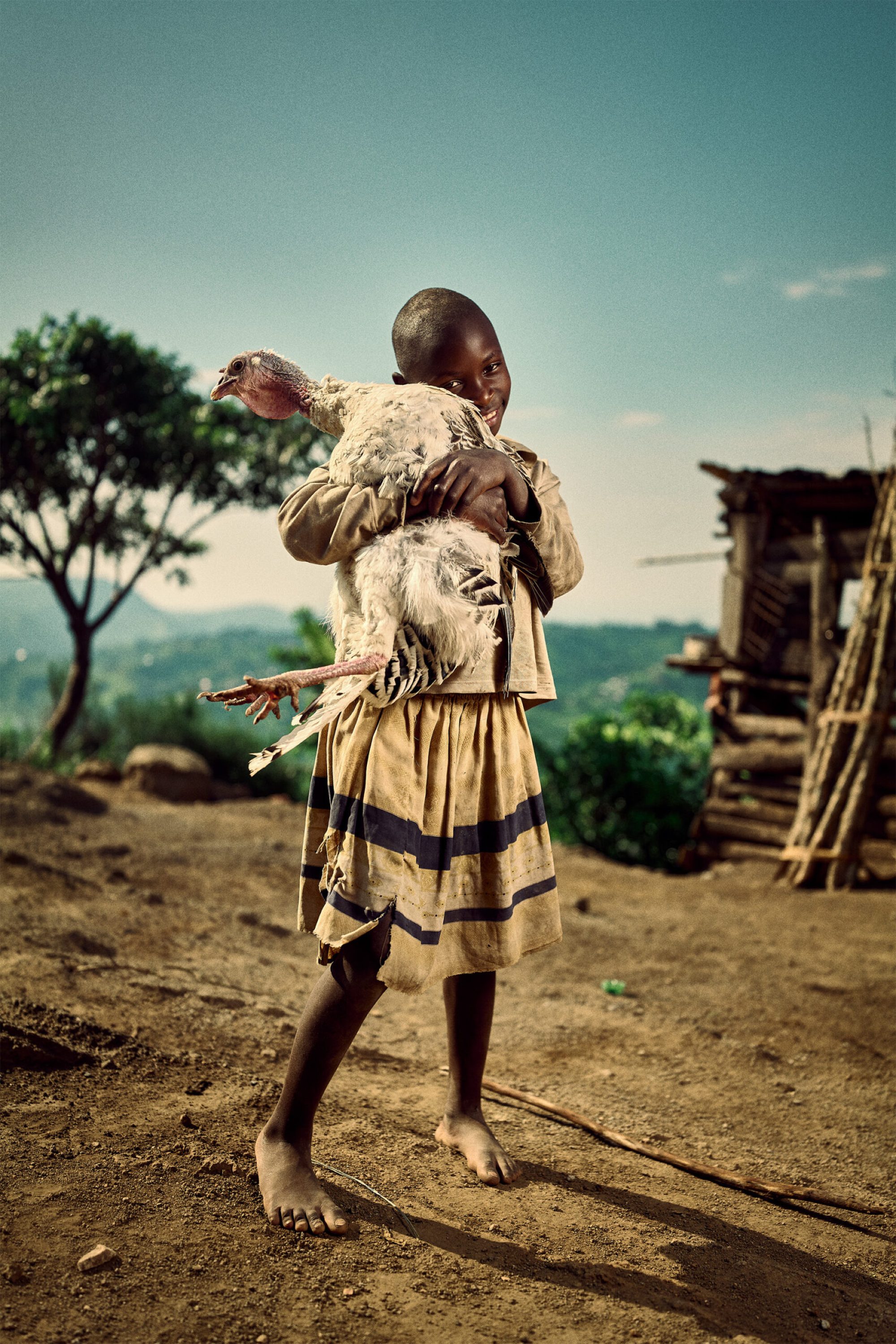 Child of coffee farmer, proud of her turkey.